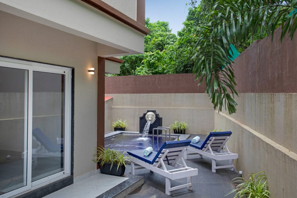 Private pool area of a luxury villa in North Goa with sun loungers at Candolim